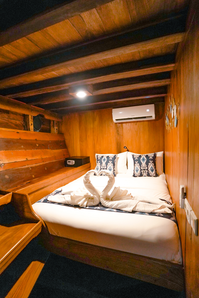 Compact double guest cabin on Adishree with in-cabin safe, reading light and ikat linens