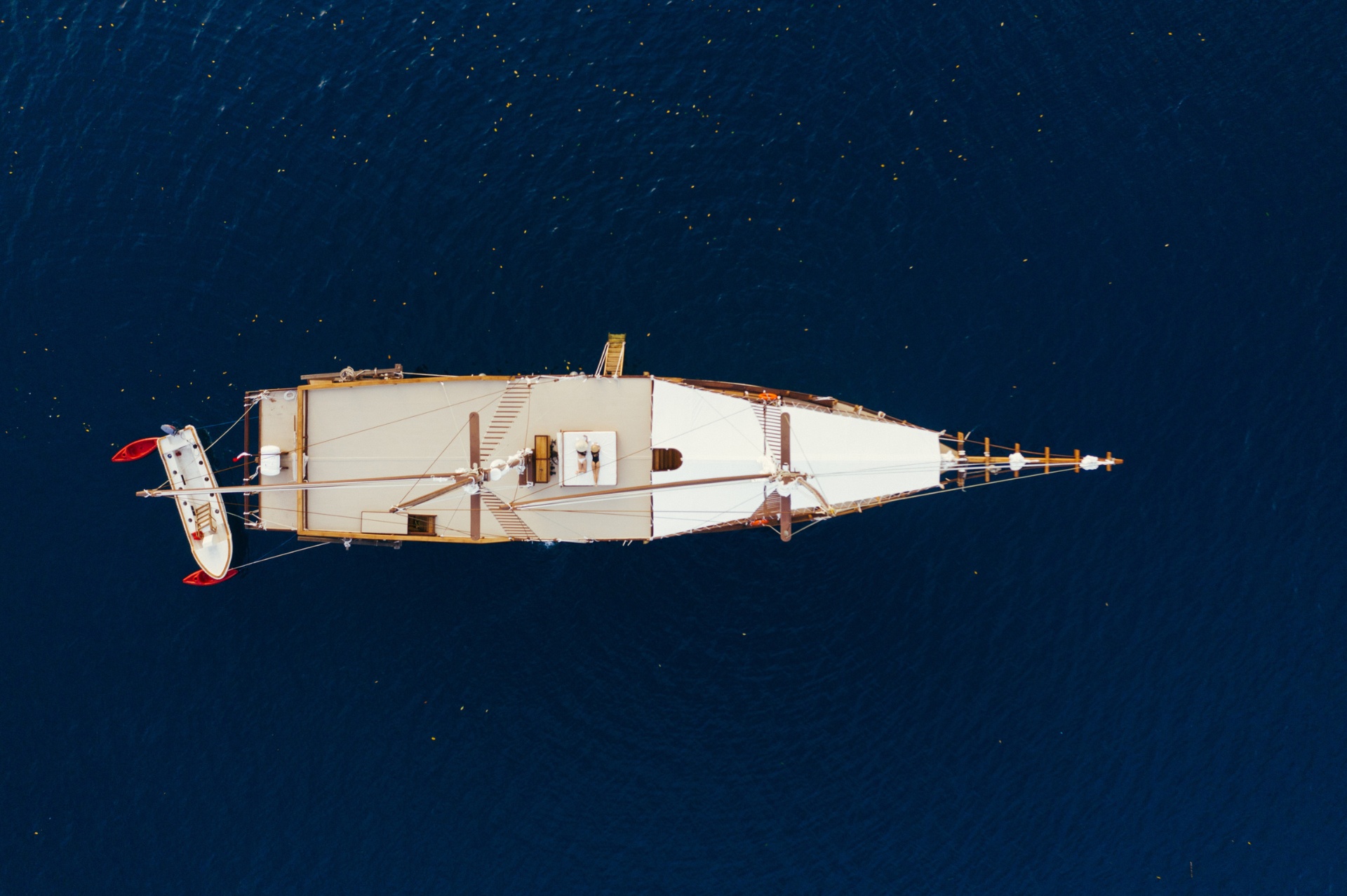 Top-down aerial of Senja on deep blue water with sundeck and tender visible