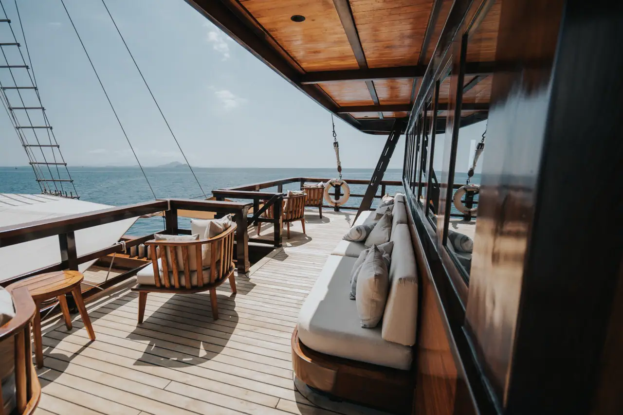 Celestia side deck lounge with teak armchairs and sea view