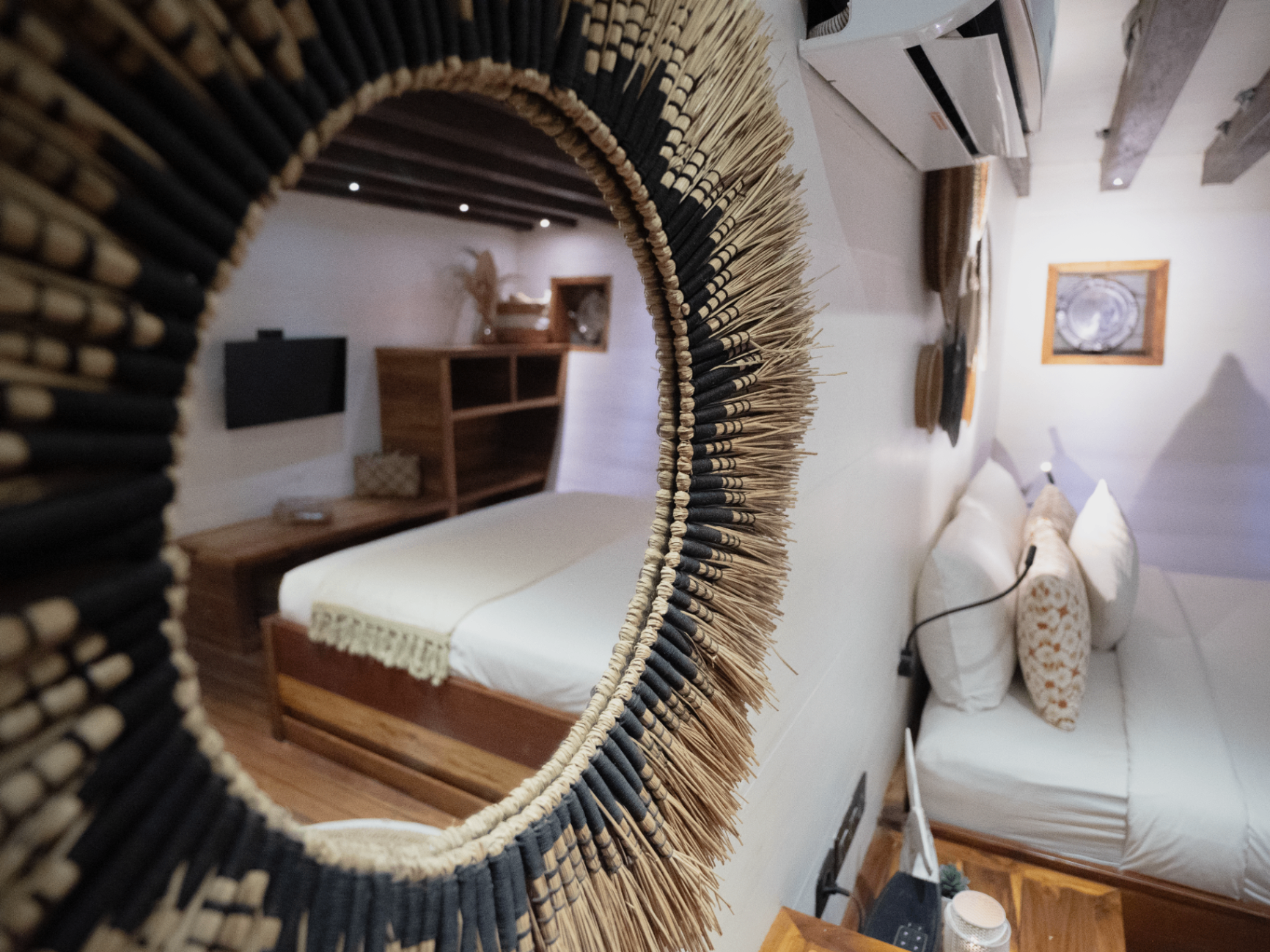 Detail of woven raffia mirror in a Fenides master cabin