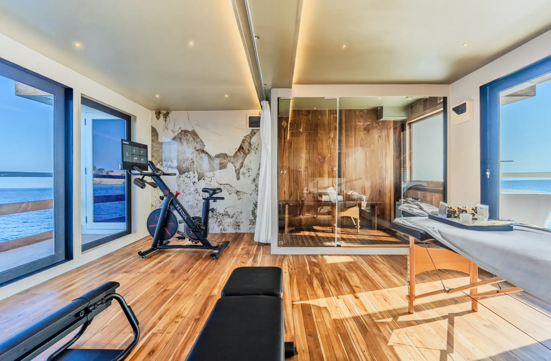 Wellness suite on Kayra with sauna cabin, spin bike and treatment table