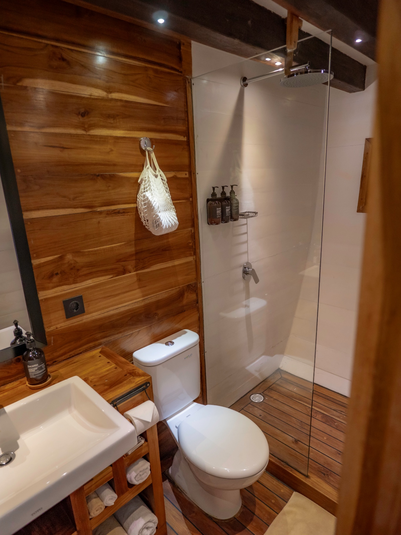 En-suite bathroom on Fenides with teak walls and rain shower