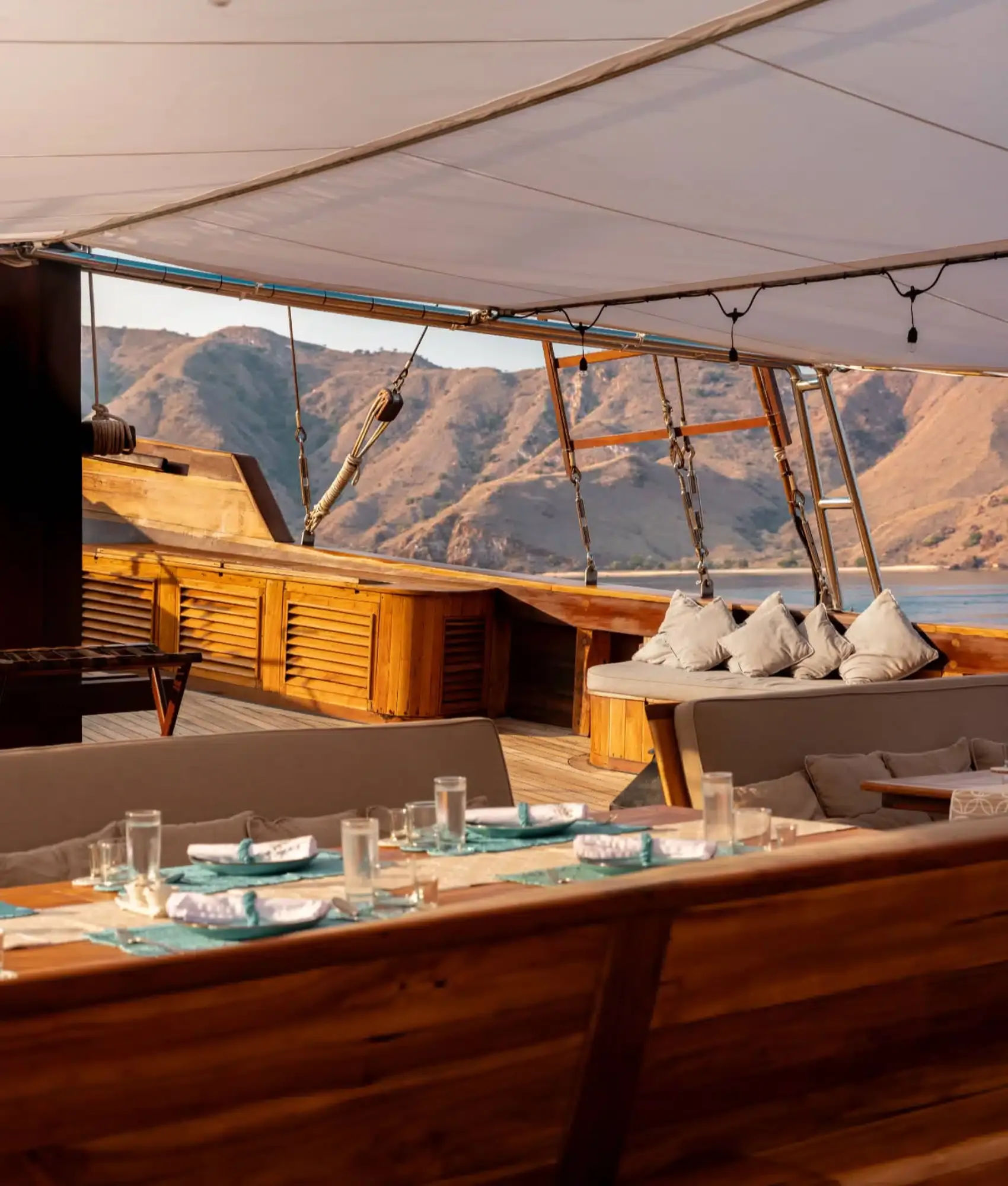 Alfresco dining table set on Prana by Atzaró's shaded main deck with island views