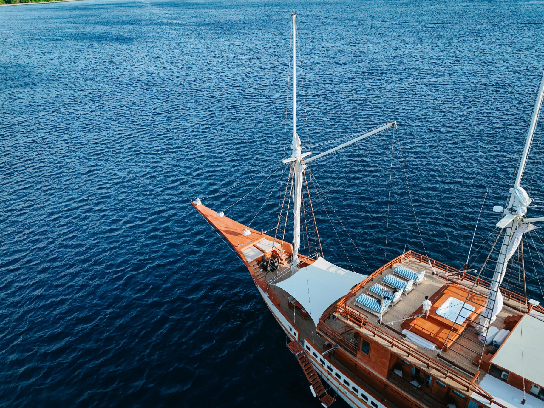 Aerial of Sanctuary's teak bow and sun-lounger sundeck with jacuzzi from above