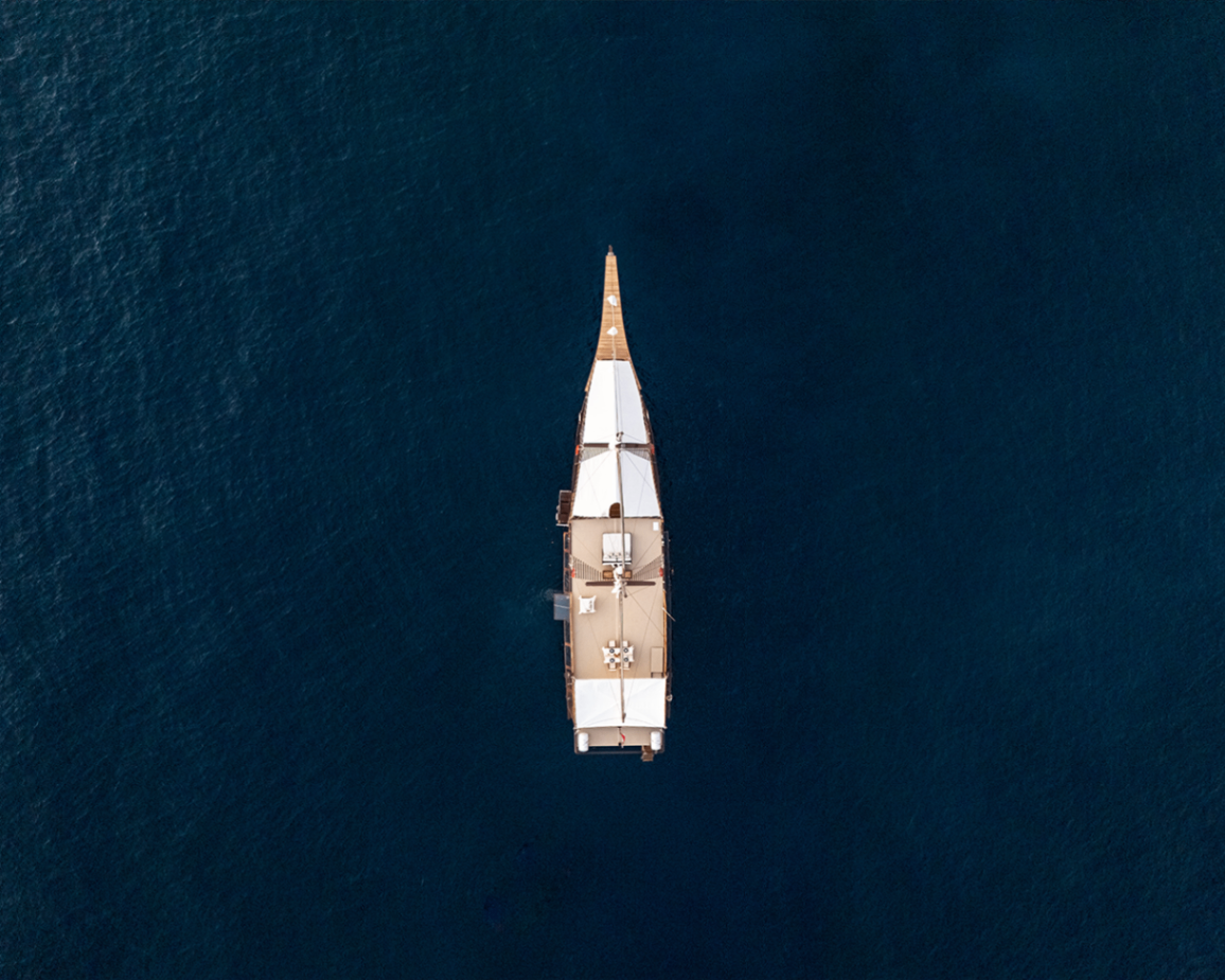 Symmetrical top-down aerial of Sanya centered on deep blue water