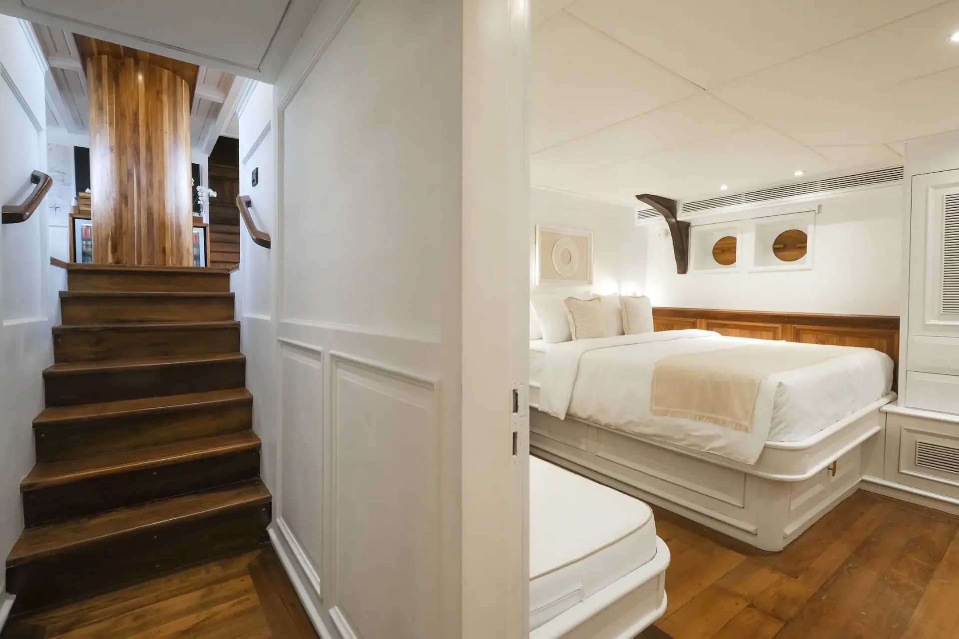 Mutiara Laut master stateroom with teak staircase leading up to the salon