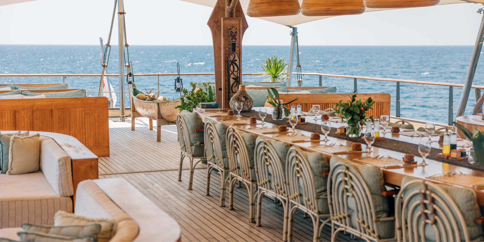 Alfresco dining table set for lunch on Kudanil Explorer's deck with ocean view