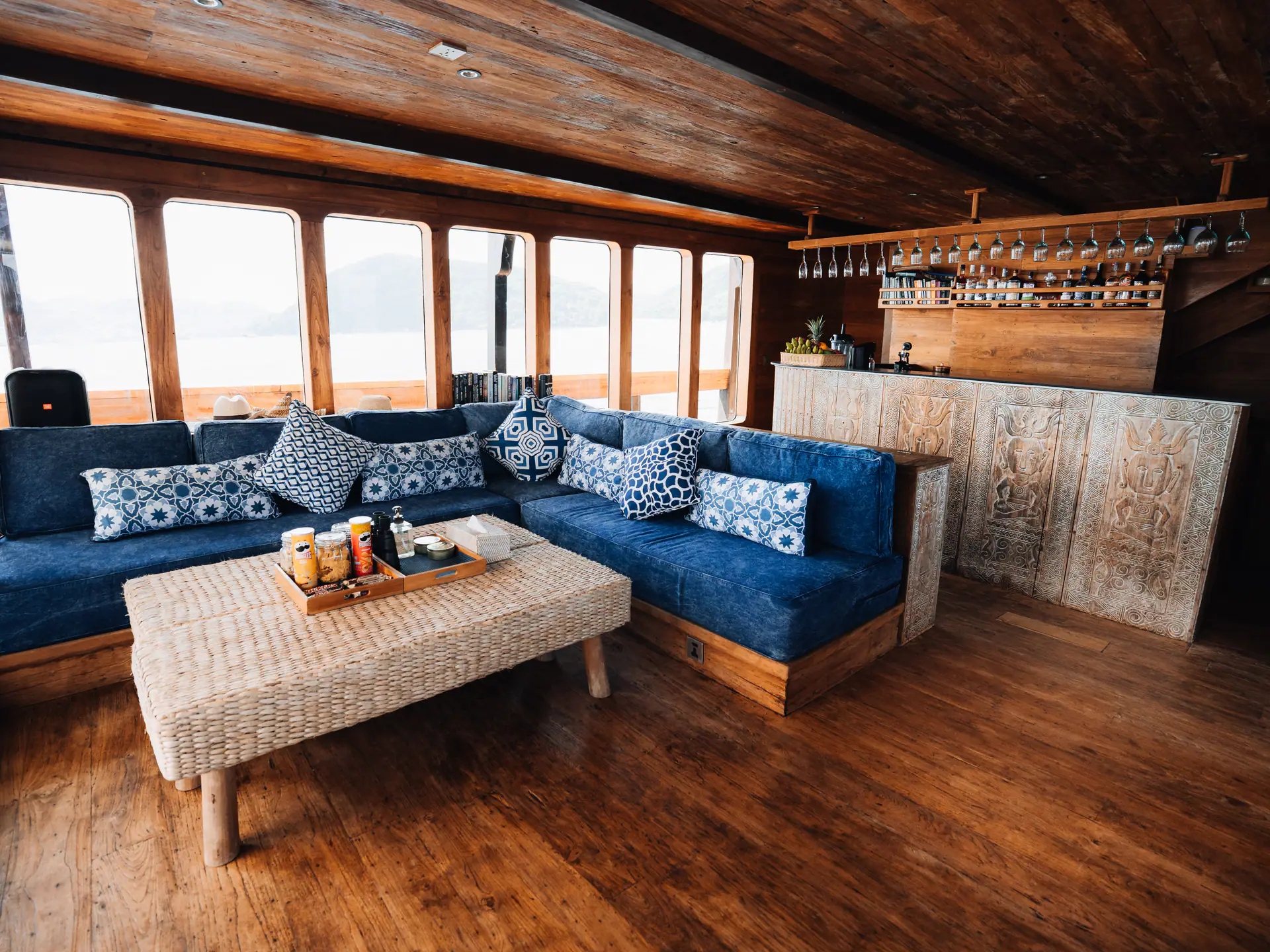 Panoramic lounge on The Oracle with indigo cushions, wine glasses above the bar and reclaimed wood floors