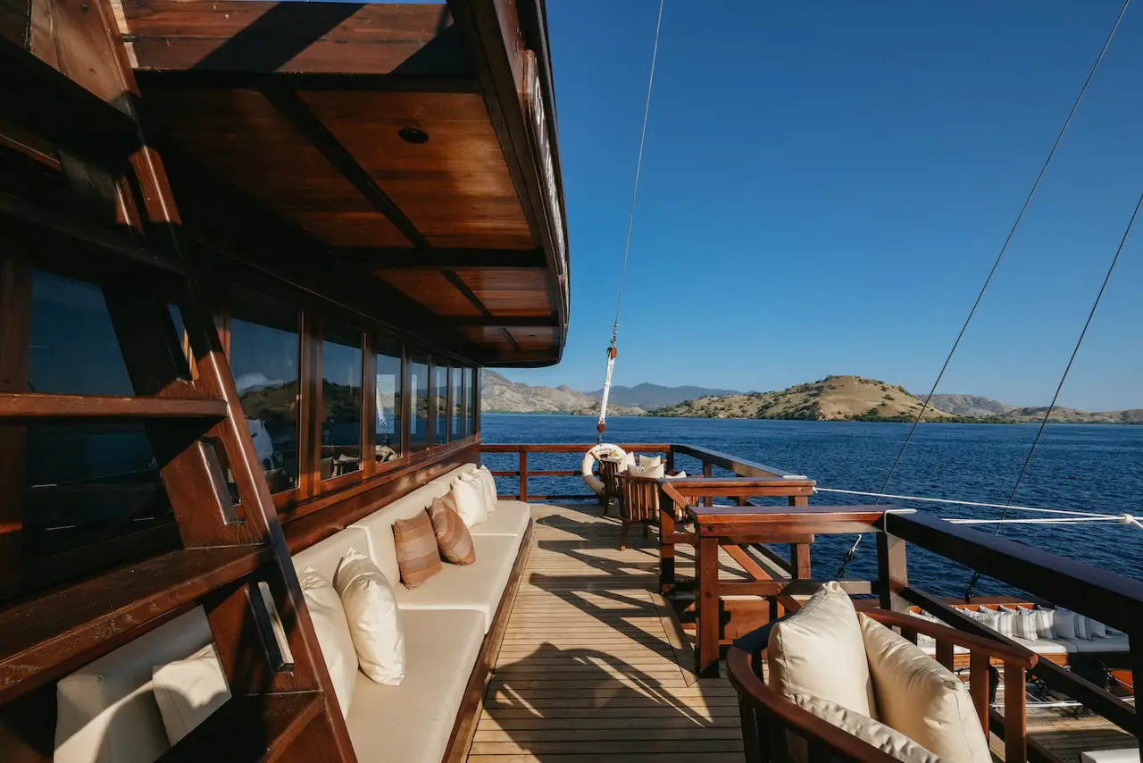 Celestia upper-deck lounge with long banquette and Komodo island view
