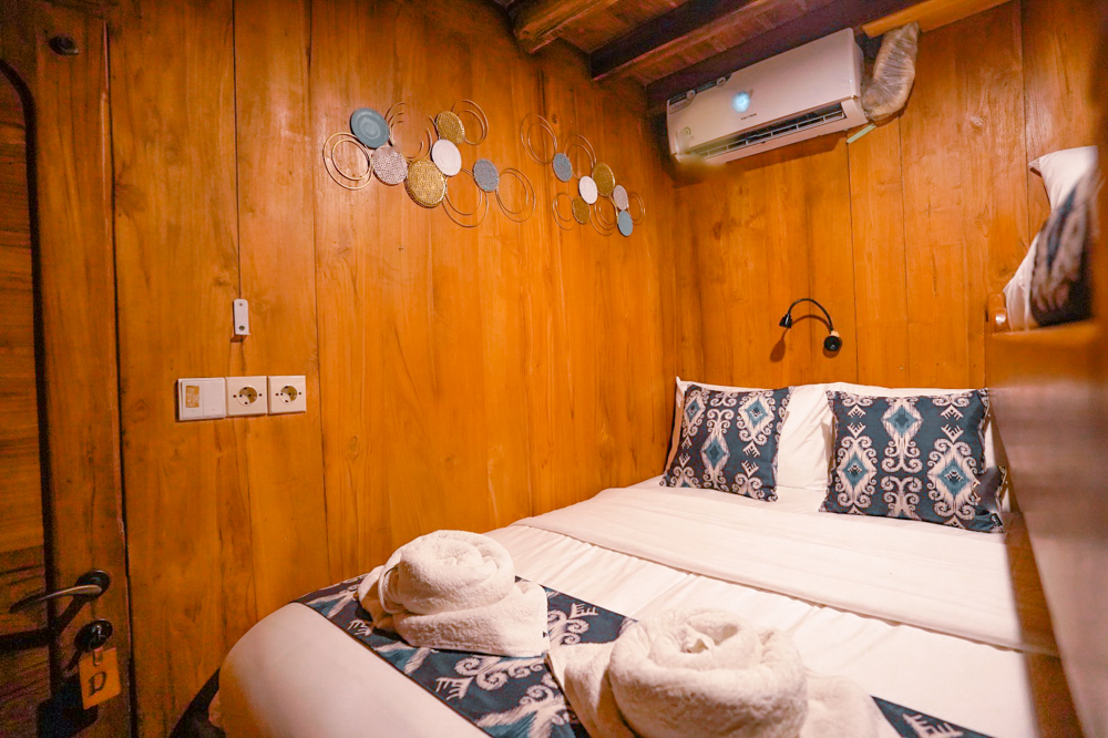 Warm-toned double cabin on Adishree with metal wall art and ikat-dressed bed