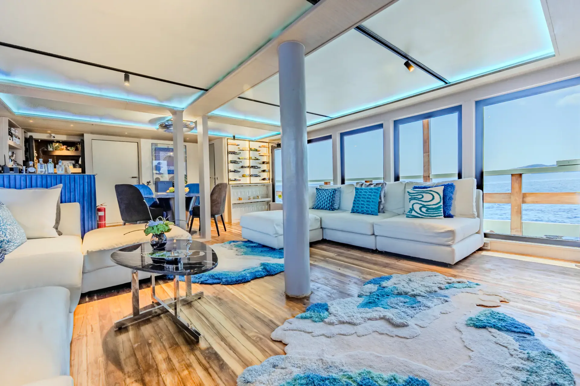 Kayra Phinisi indoor lounge with ocean-view sofa, bar and wine display