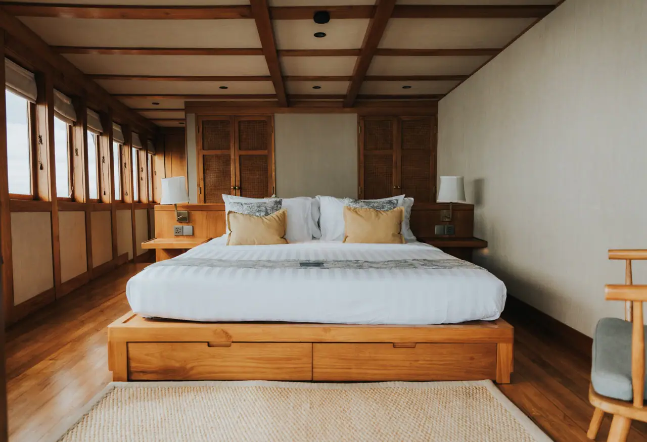 Celestia owner's stateroom with king bed and wraparound windows