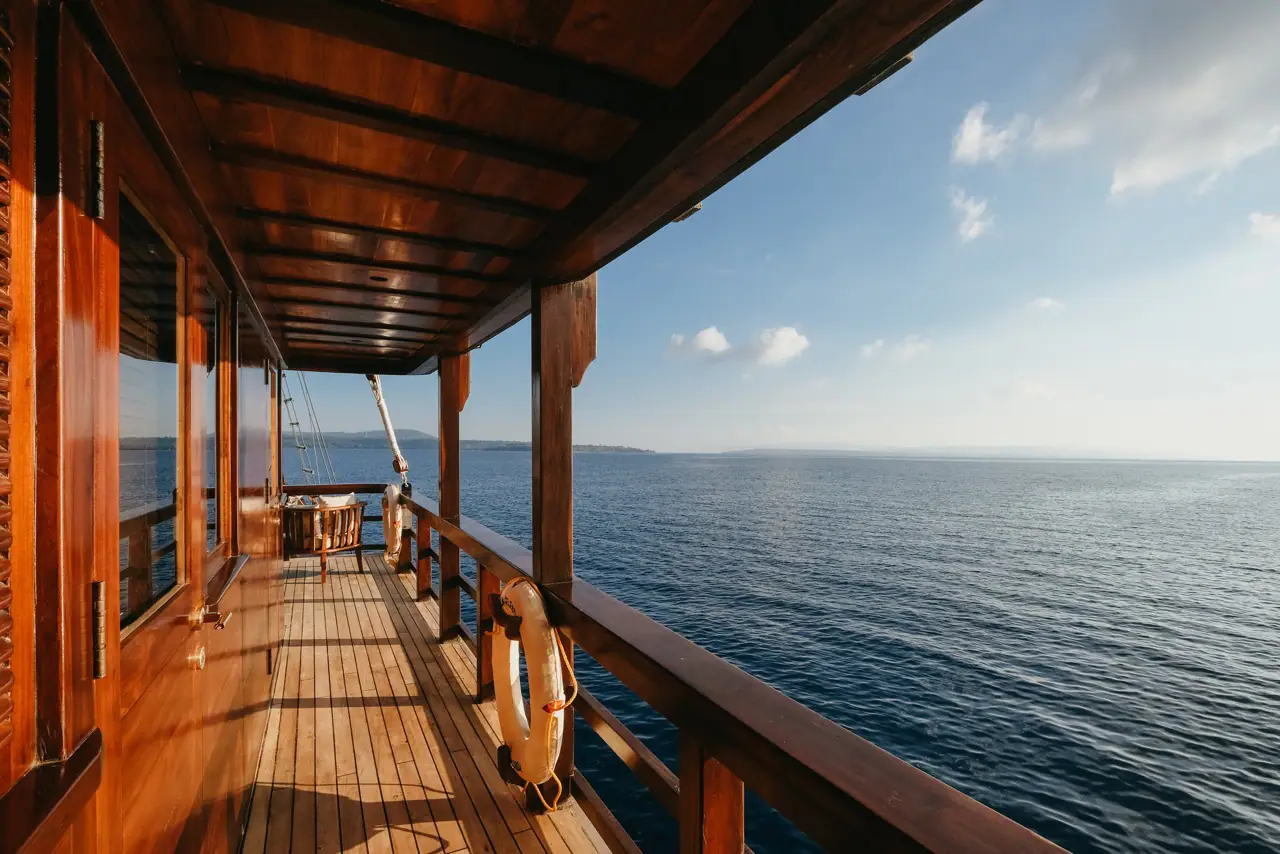Celestia teak side walkway with life ring and open ocean beyond