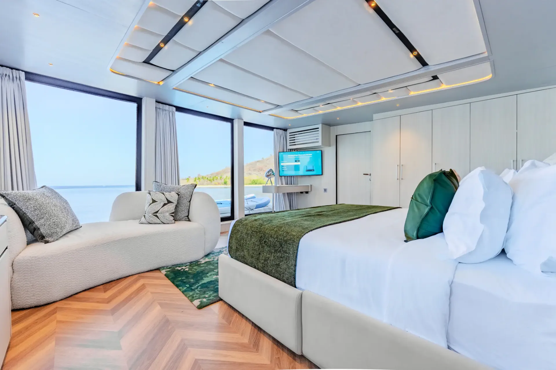 Kayra master suite with king bed, chaise longue and floor-to-ceiling ocean windows