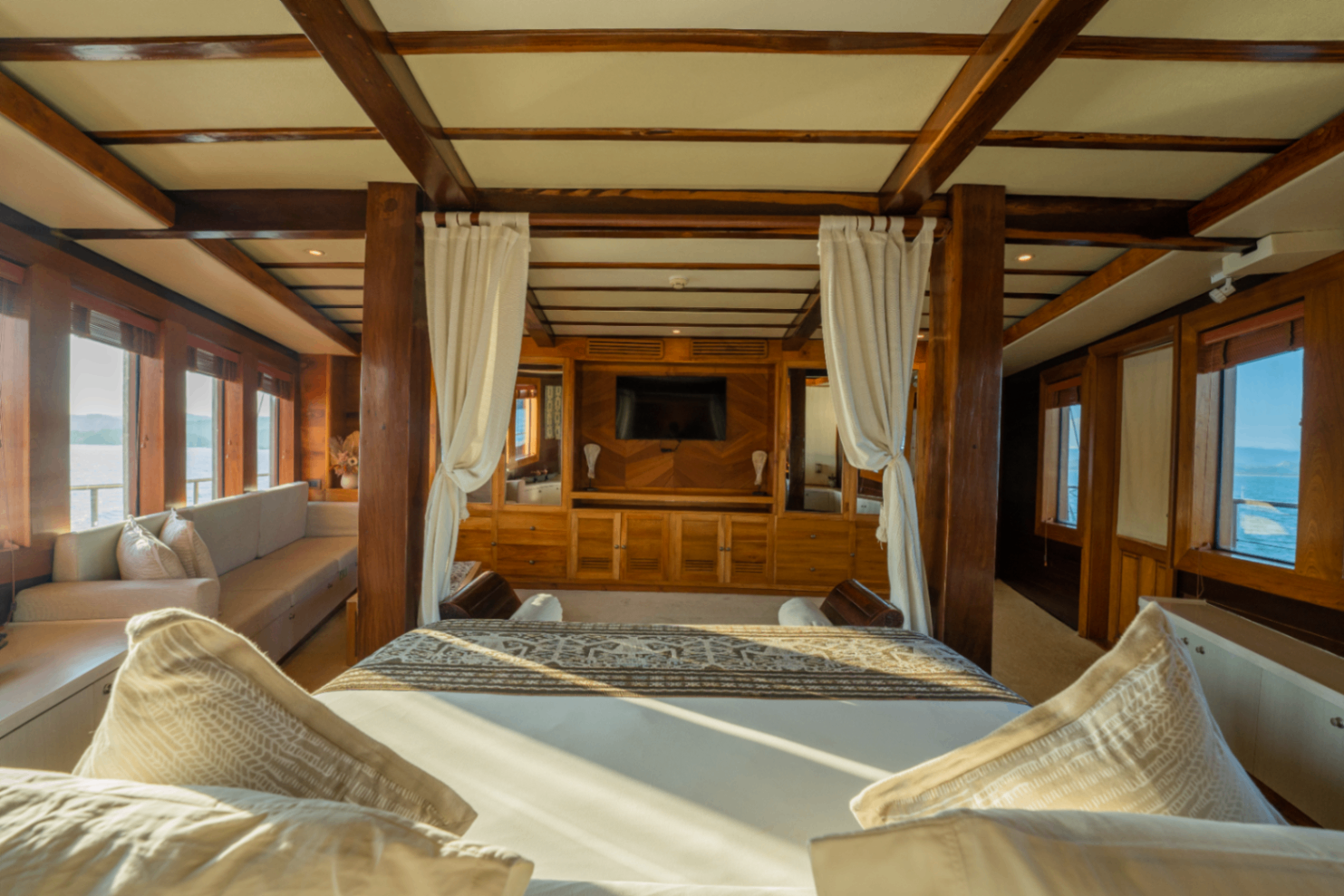 View from Lamima's master bed toward the entertainment cabinet with wraparound sea-view windows