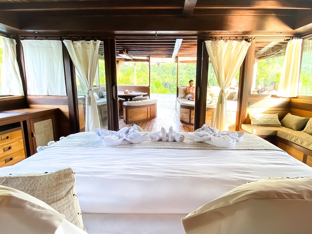 Master cabin on Senja with king bed dressed in white linen, doors opening to the aft deck