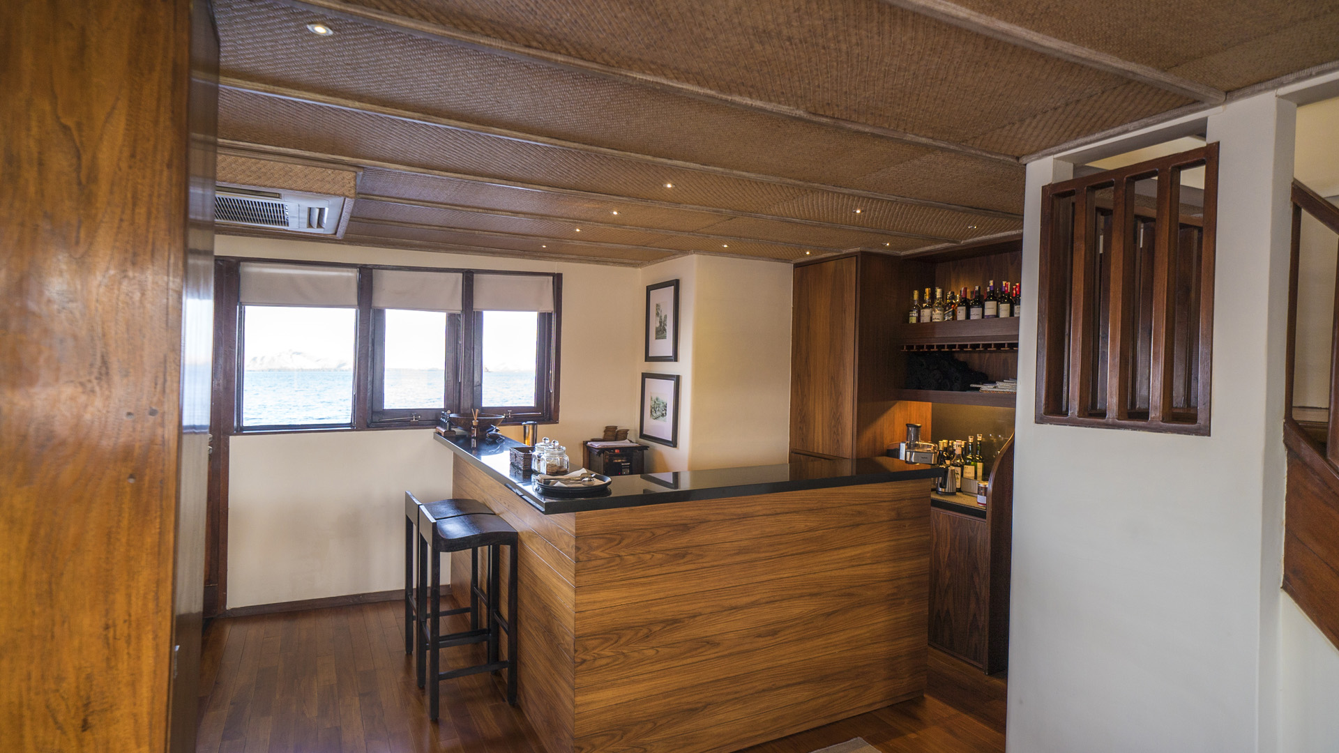 Alila Purnama bar with teak counter, wine storage and window seating