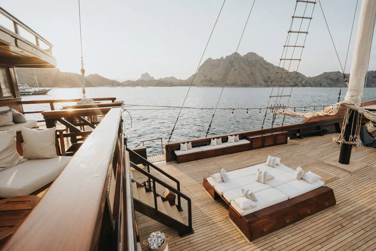 Celestia sundeck at sunset with daybeds and dry islands in the background