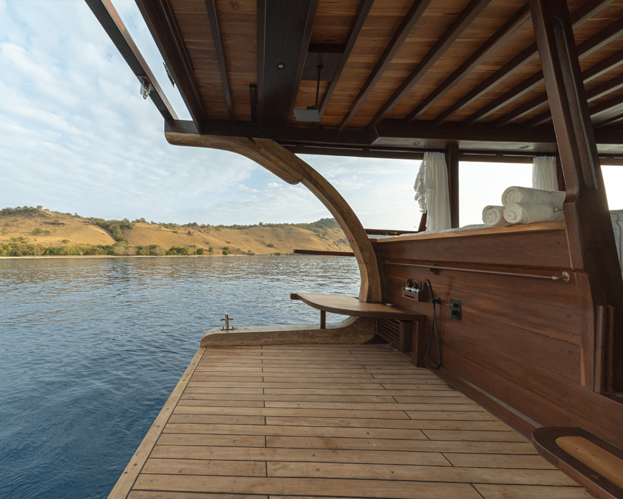 Sanya swim platform and open side gate looking out to calm water and Komodo hills