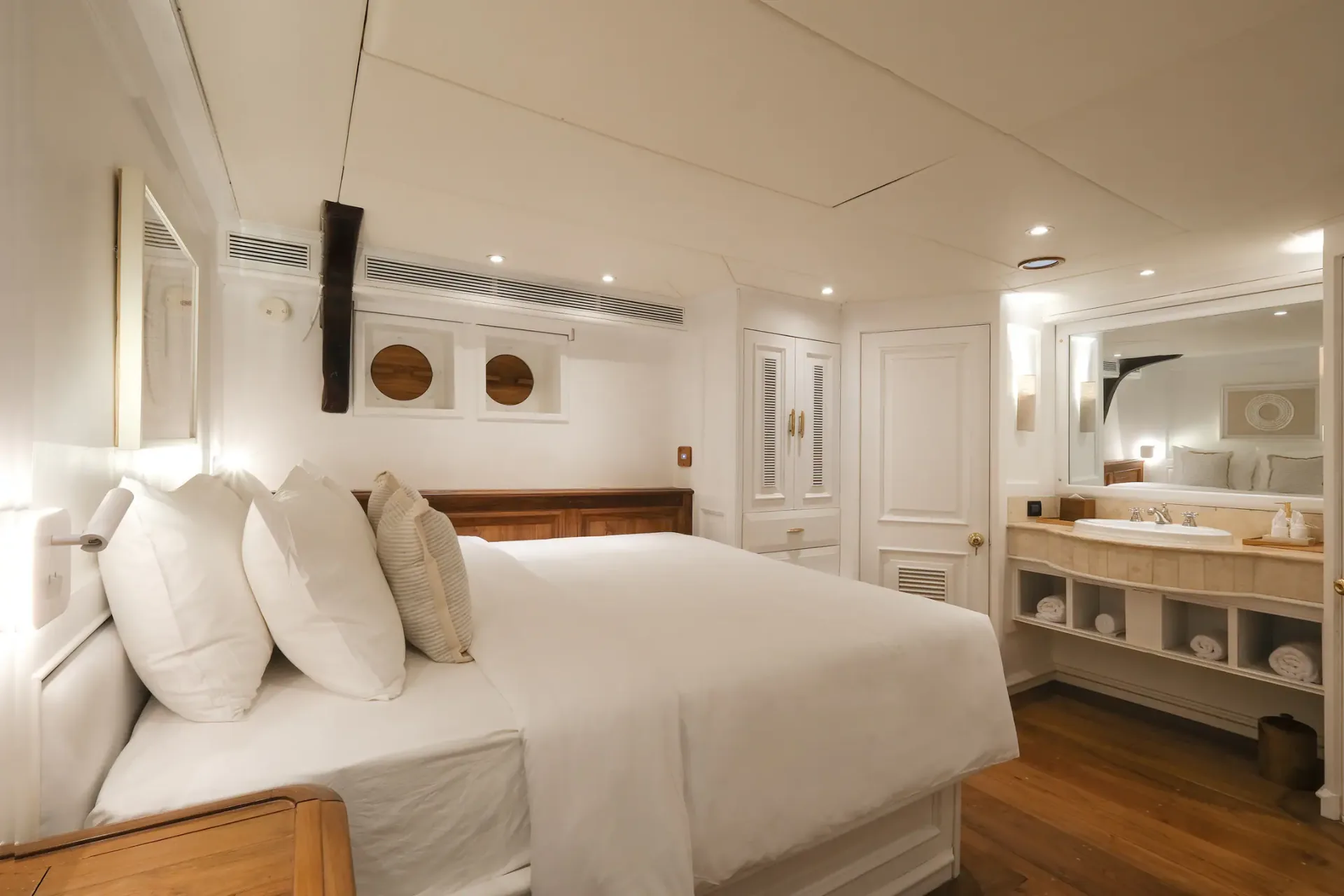 Mutiara Laut master stateroom with king bed and marble ensuite vanity