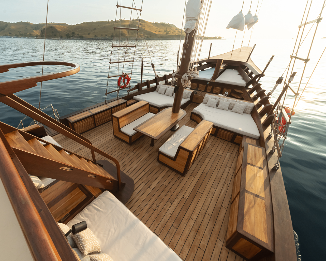 Elevated view over Sanya's shaded foredeck lounge in warm late-afternoon light