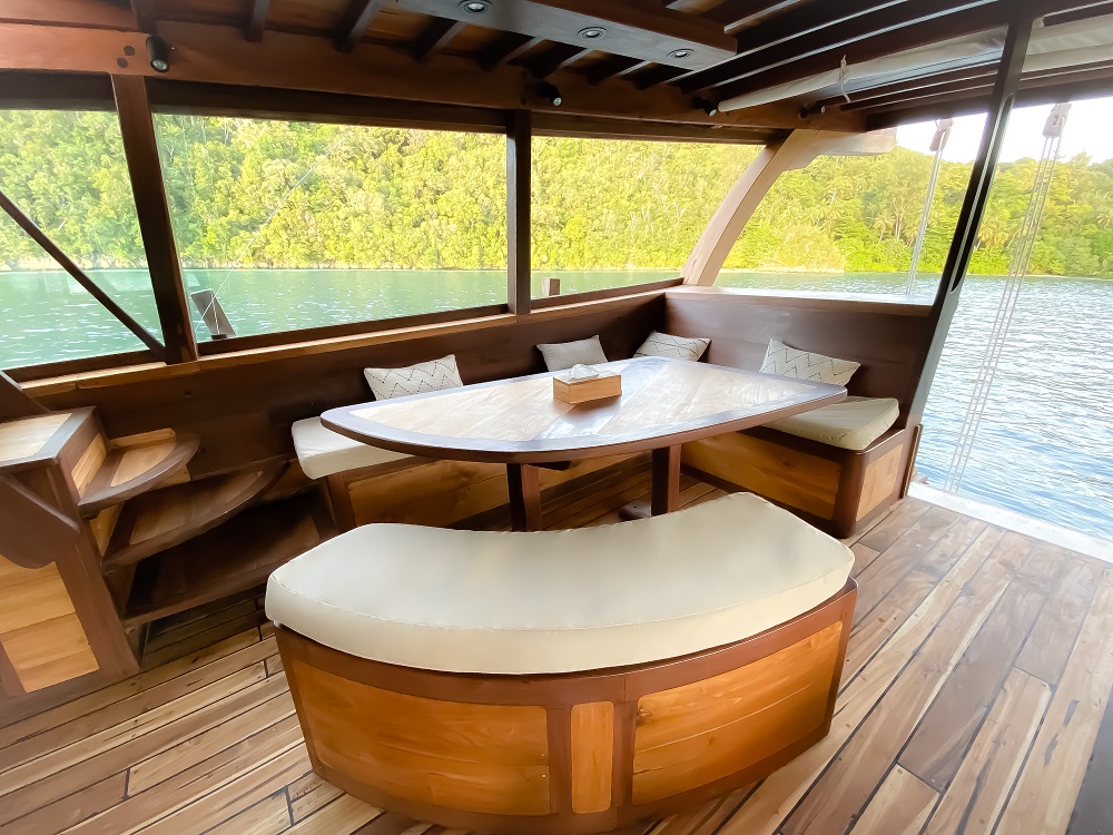 Wooden dining nook on Senja with panoramic windows over Raja Ampat