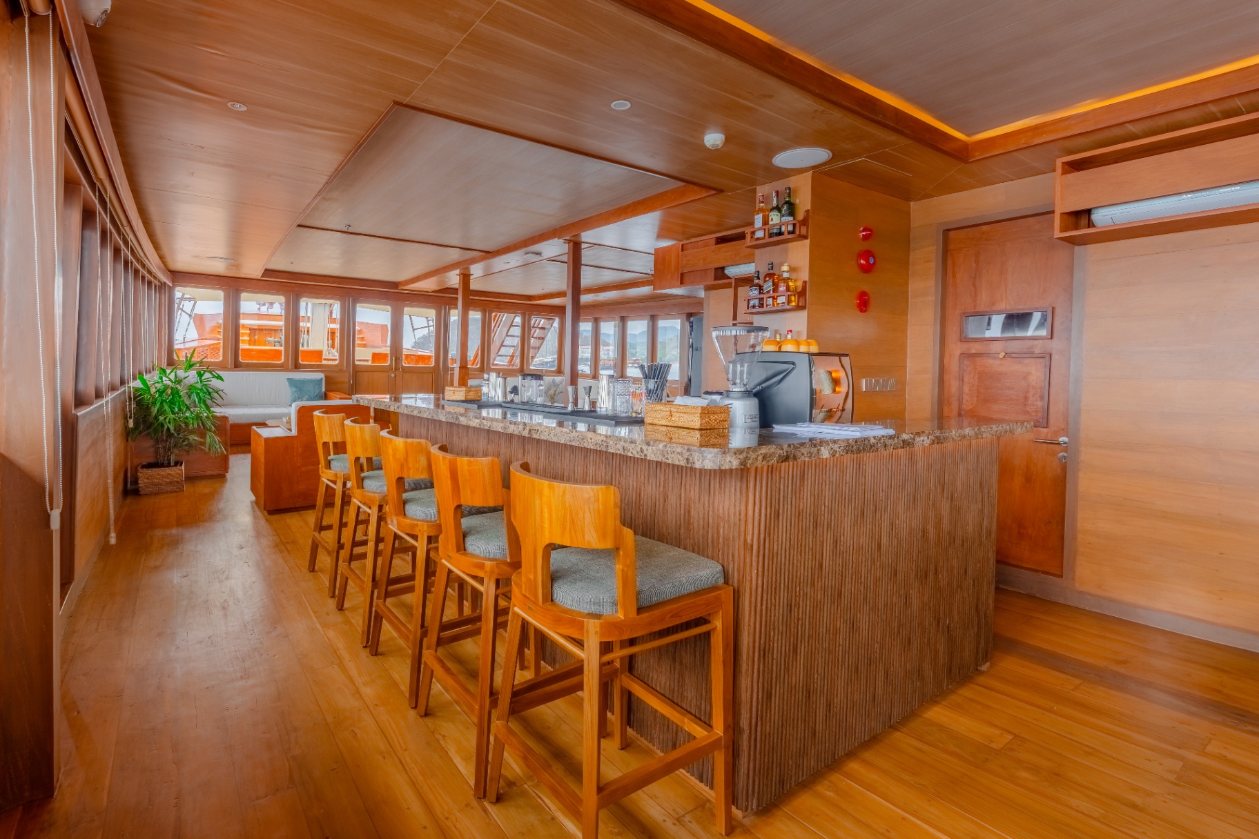 Sanctuary's indoor bar with stone counter, teak bar stools and coffee station