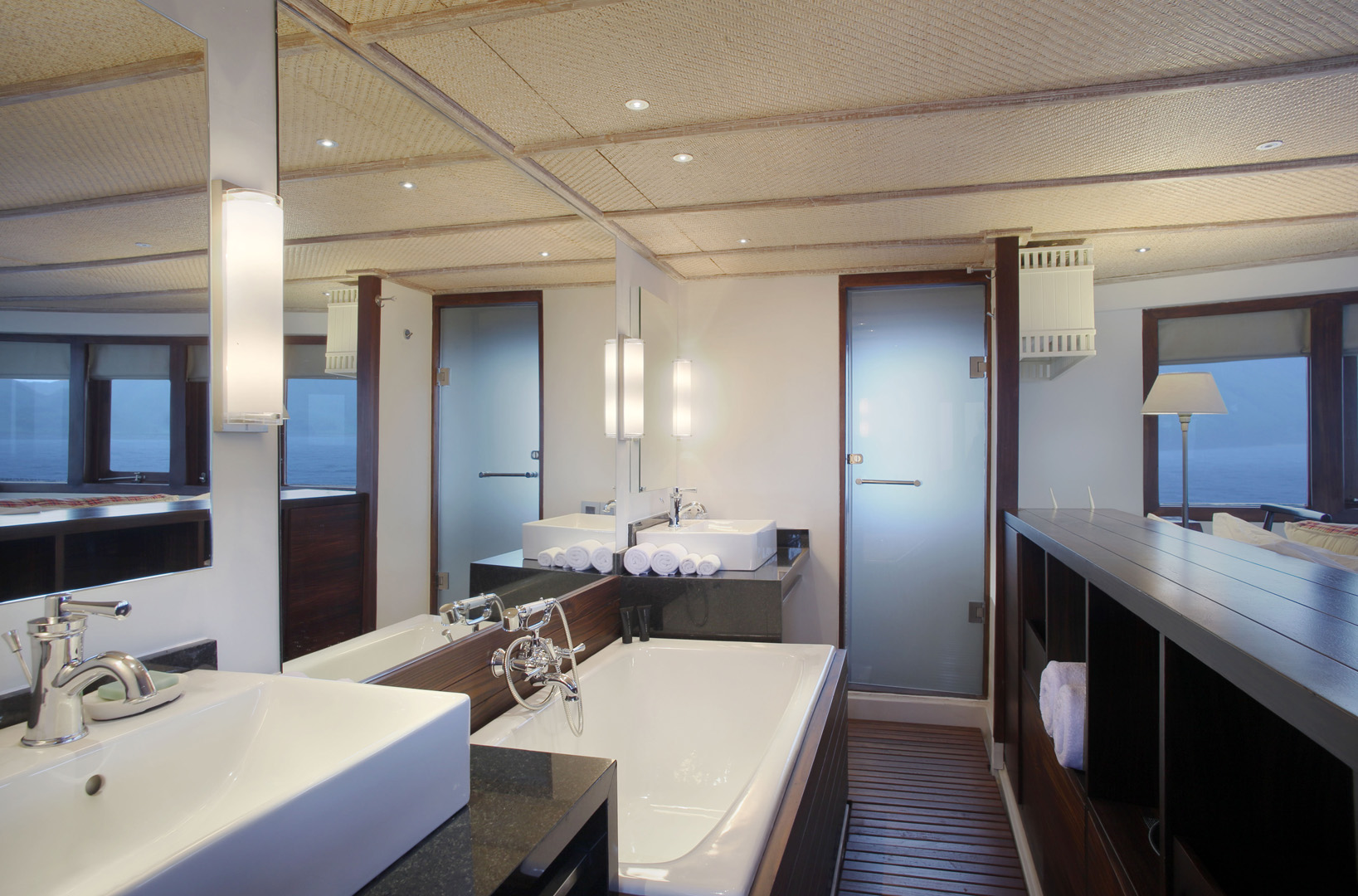 Master suite ensuite bathroom on Alila Purnama with bathtub, twin vanities and rain shower