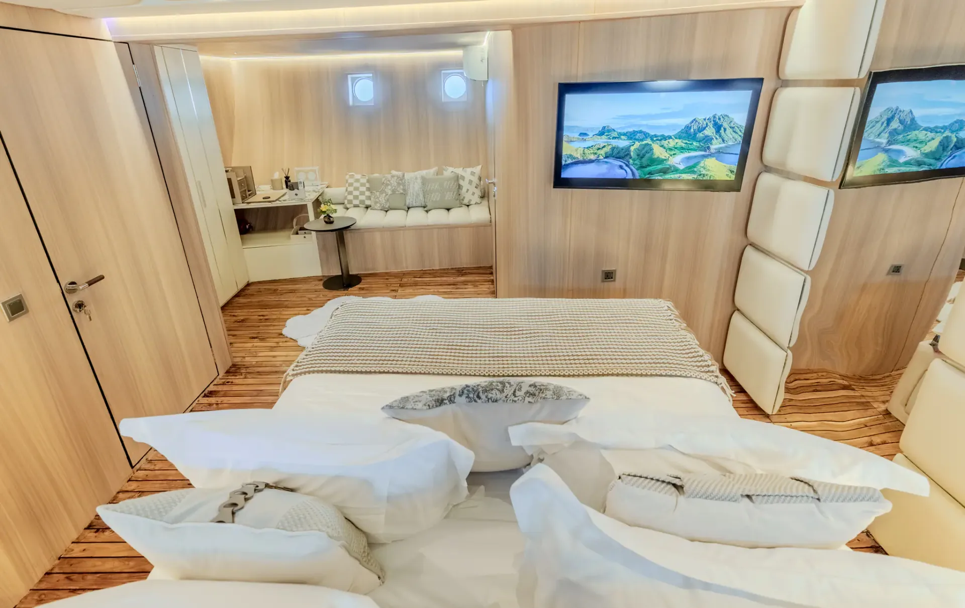 Guest cabin with king bed, artwork panels and adjoining lounge seat