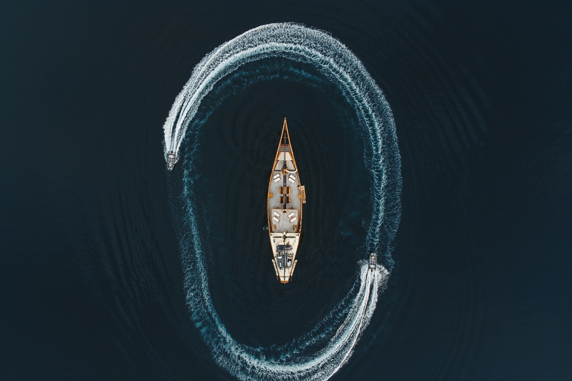 Aerial view of Silolona at anchor with two tenders circling the yacht