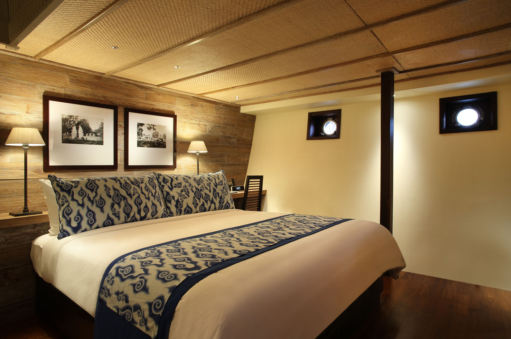 Cirebon Suite on Alila Purnama with king bed, indigo textiles and twin portholes