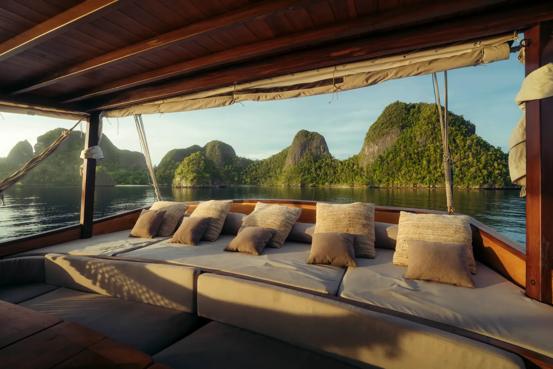 Bow daybed on Anne Bonny with karst island views at golden hour