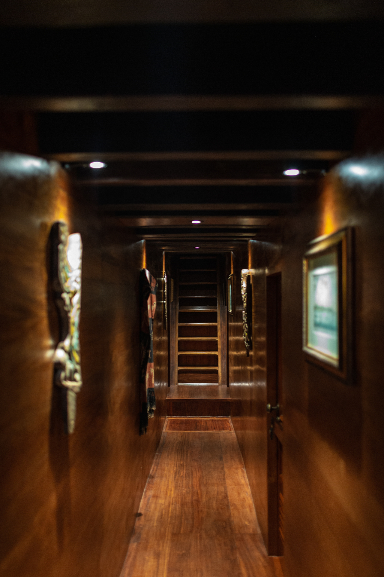 Warmly lit timber companionway on Silolona leading up to the main deck