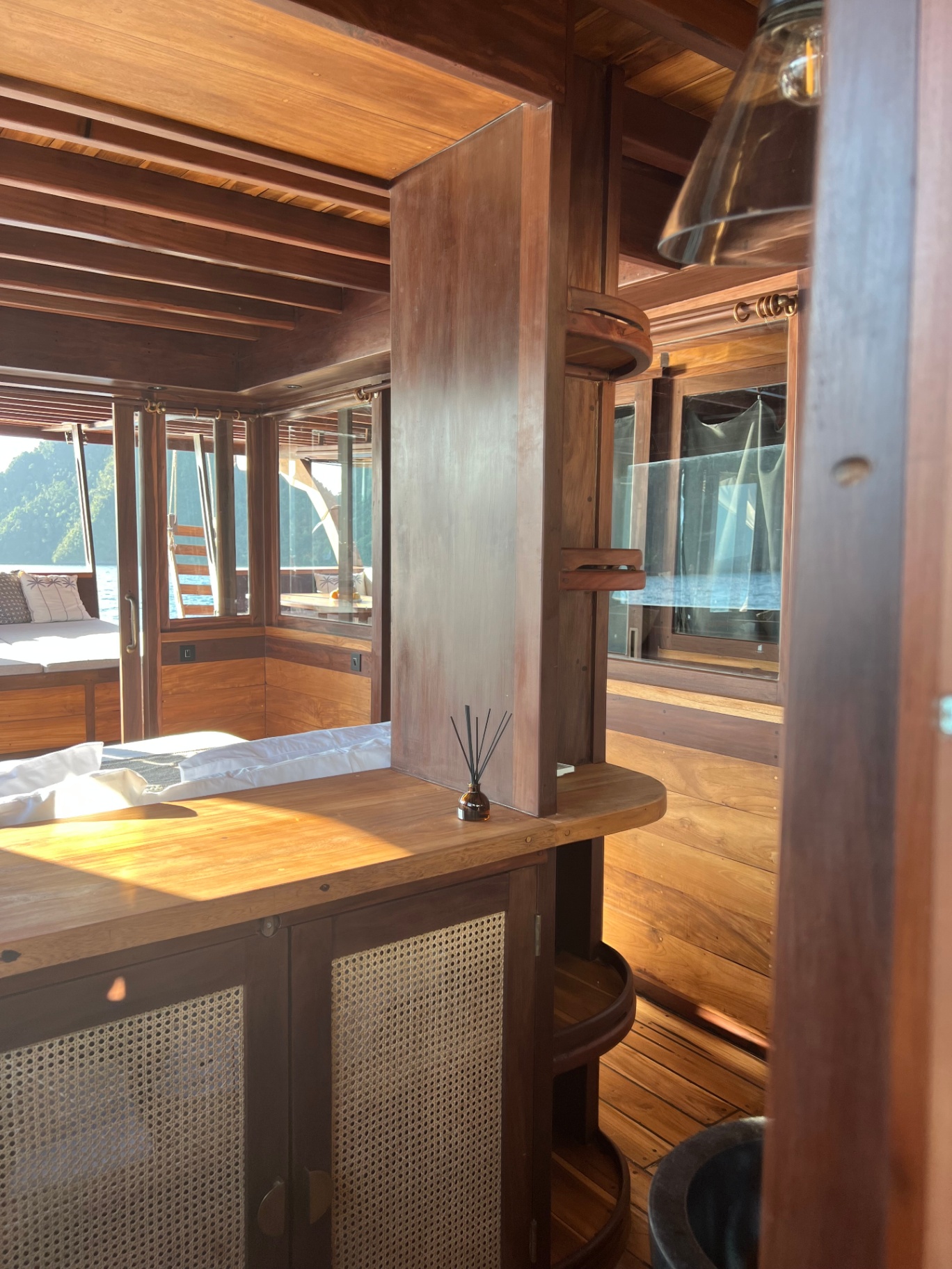 Passage through the master cabin bathroom on Dewata with view onto the bed and sea