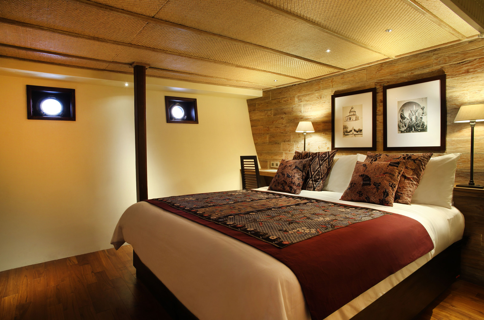 Madura Suite on Alila Purnama with king bed, portholes and batik textiles