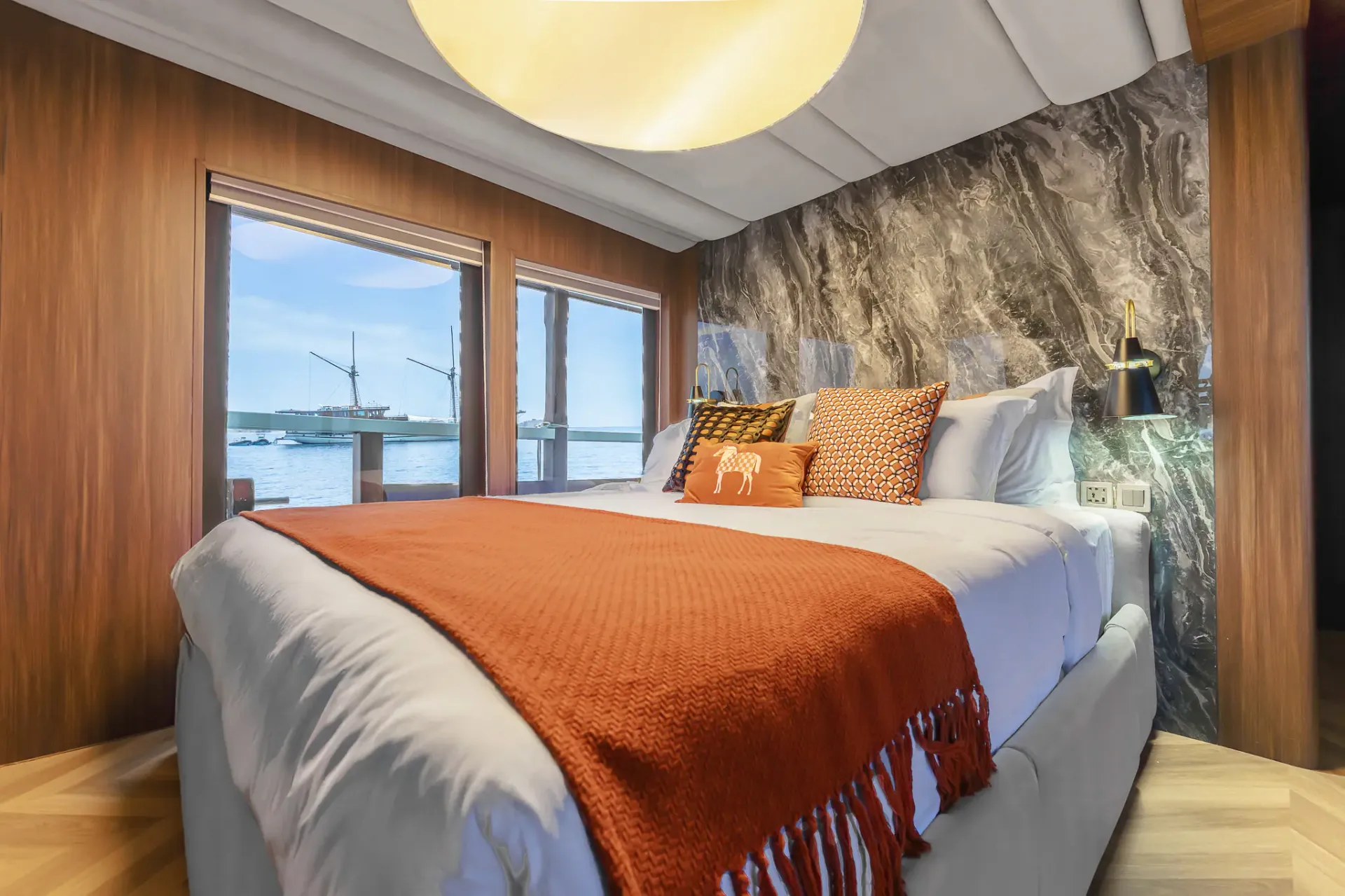 VIP cabin on Kayra Phinisi with king bed, marble headboard and sea view
