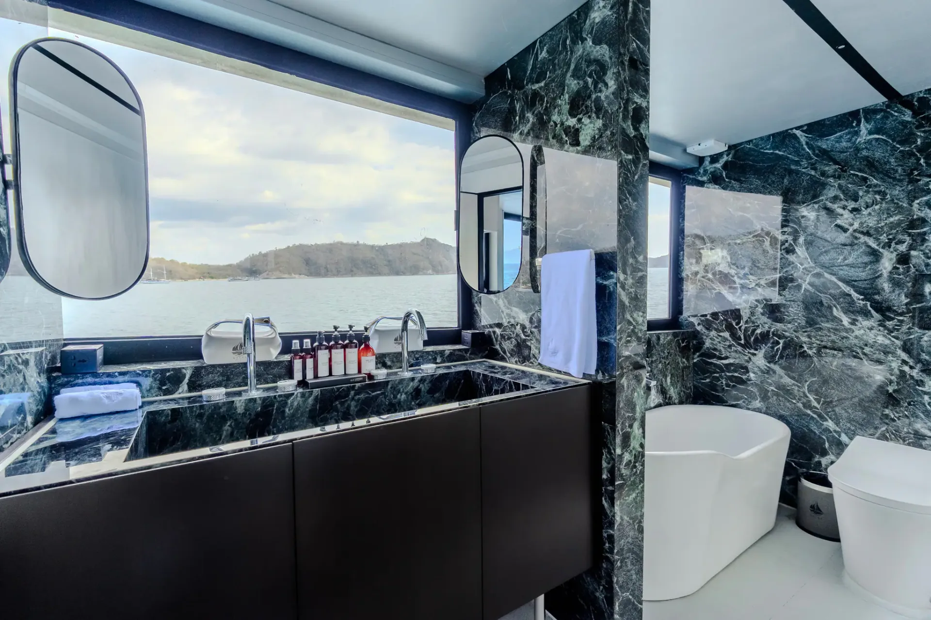 Master ensuite with green marble, freestanding tub and panoramic ocean window