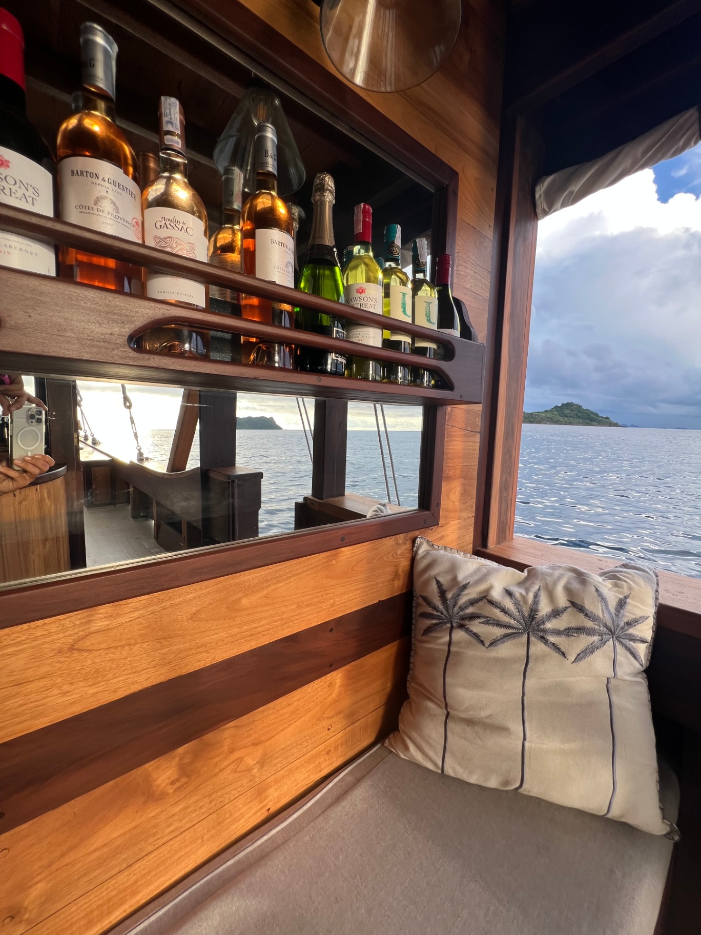 Detail of Dewata's open-air bar with wines and champagne beside a sea window