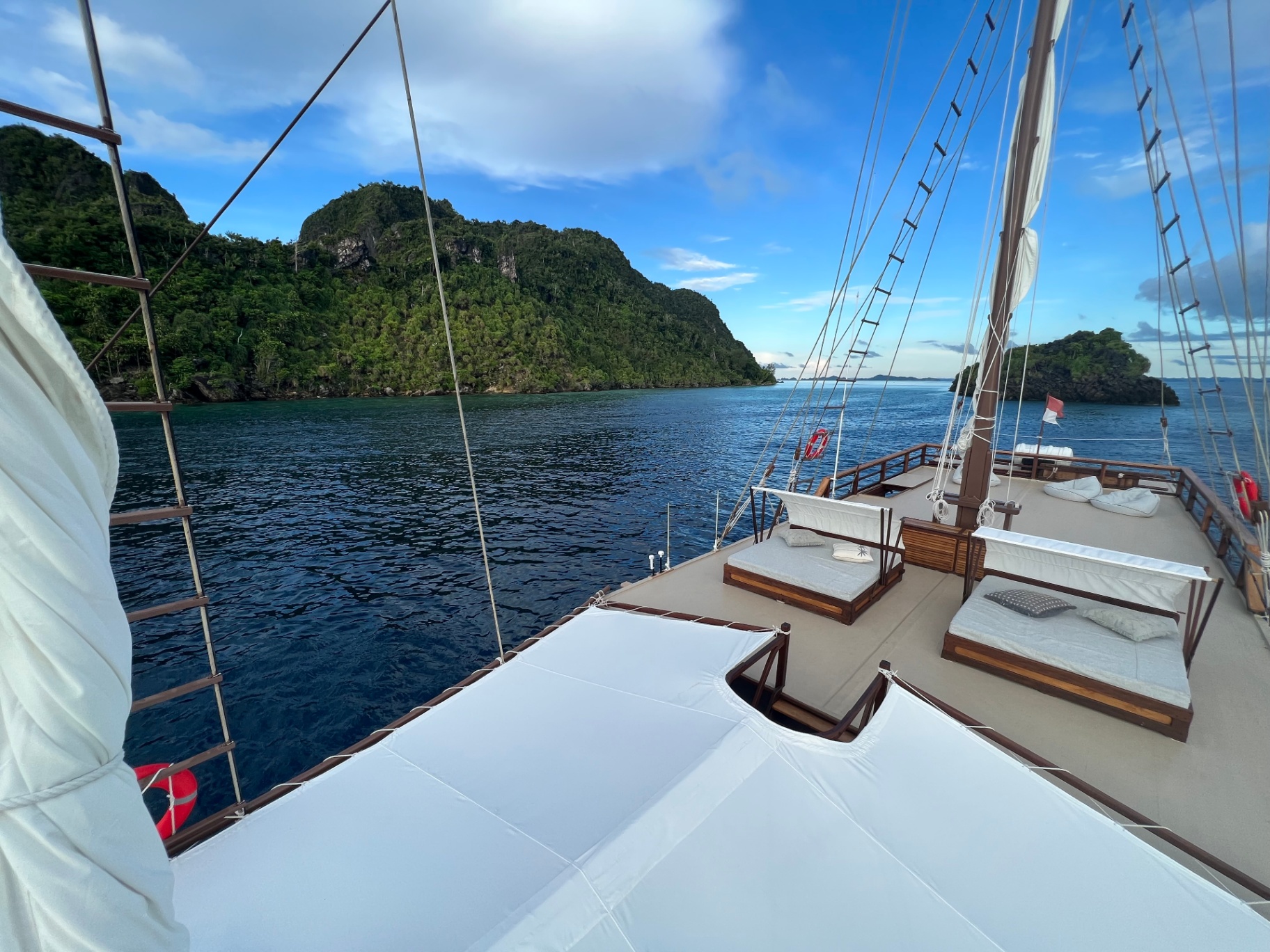 Dewata top deck sun loungers overlooking a Raja Ampat karst bay