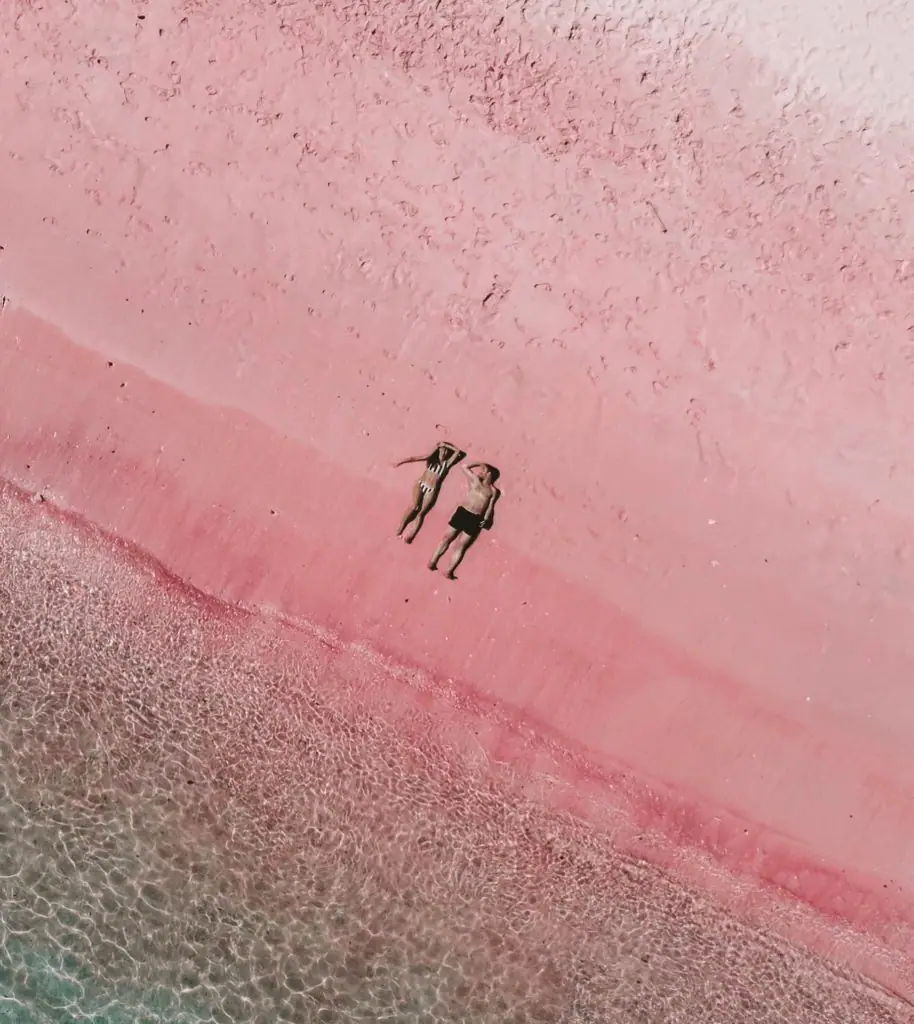 Couple lying on Pink Beach Komodo seen from above
