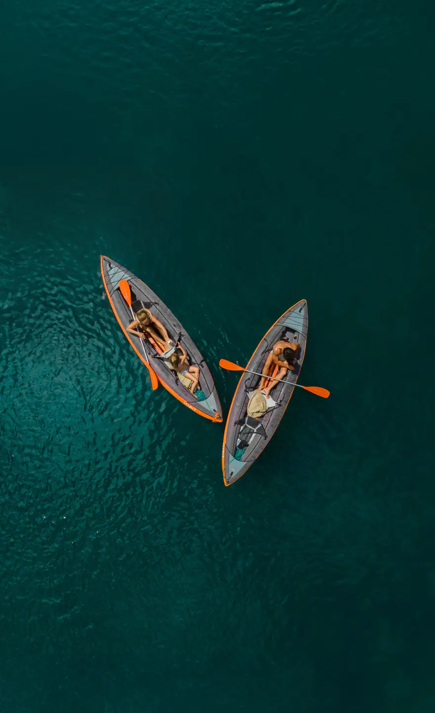 Aerial view of two kayaks paddled by Mutiara Laut guests on emerald water