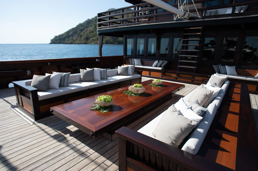 Aft deck seating area with sofas, cushions and ocean view