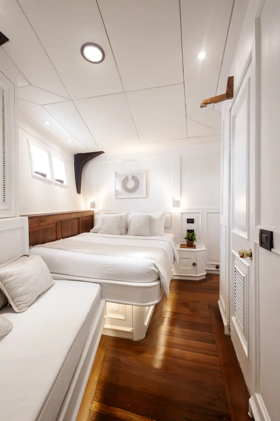 Mutiara Laut twin cabin with double bed and single berth in warm timber