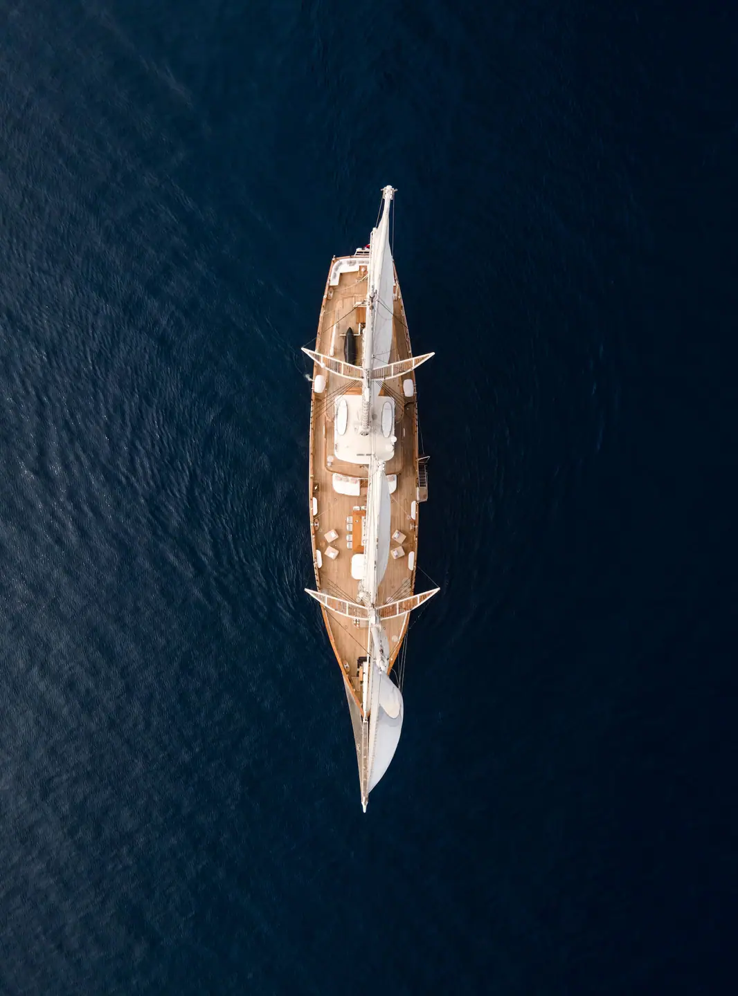 Top-down aerial of Mutiara Laut showing full deck layout on dark blue sea