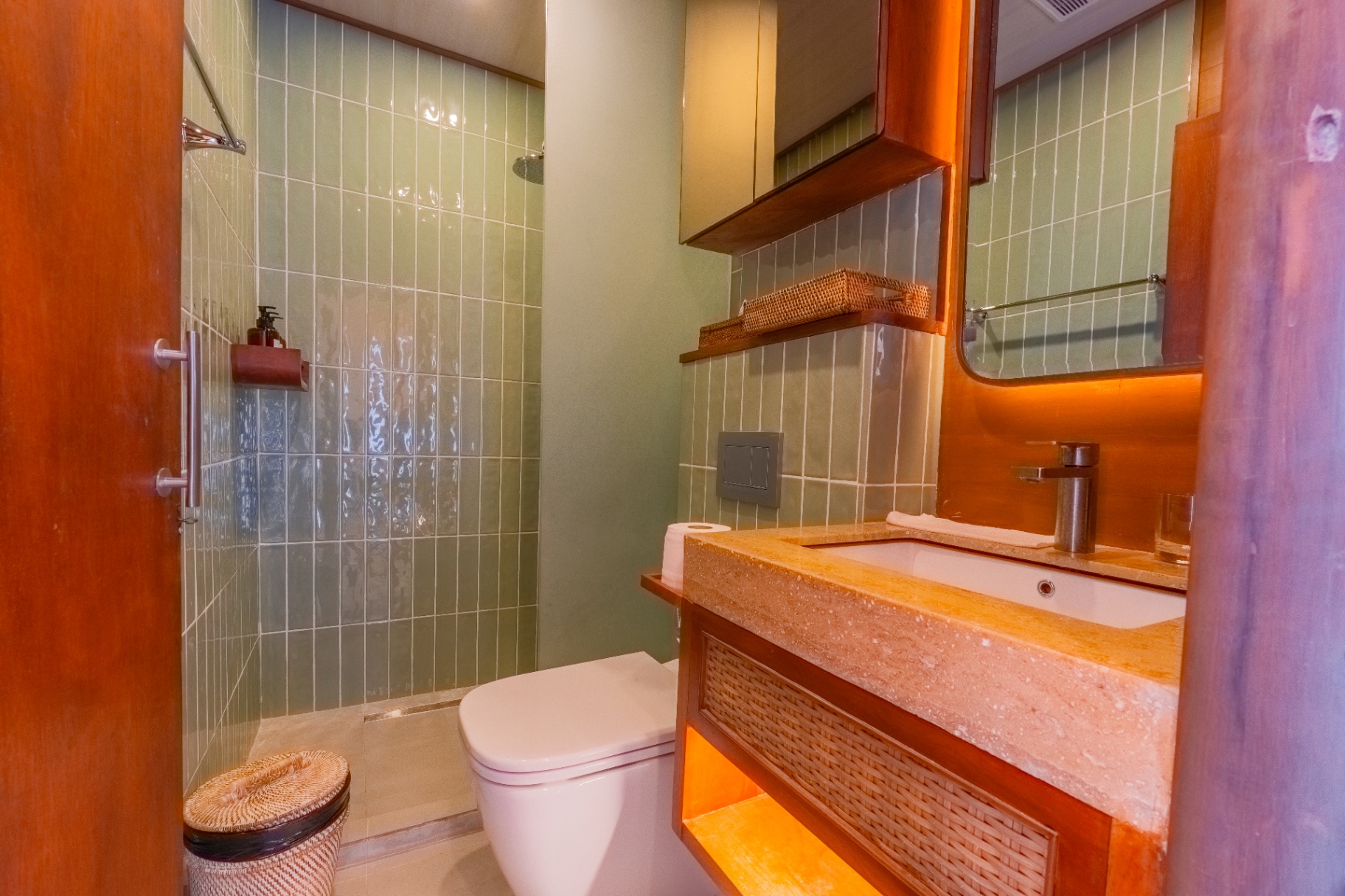 Deluxe cabin ensuite on Sanctuary with rain shower, green tiled walls and travertine vanity