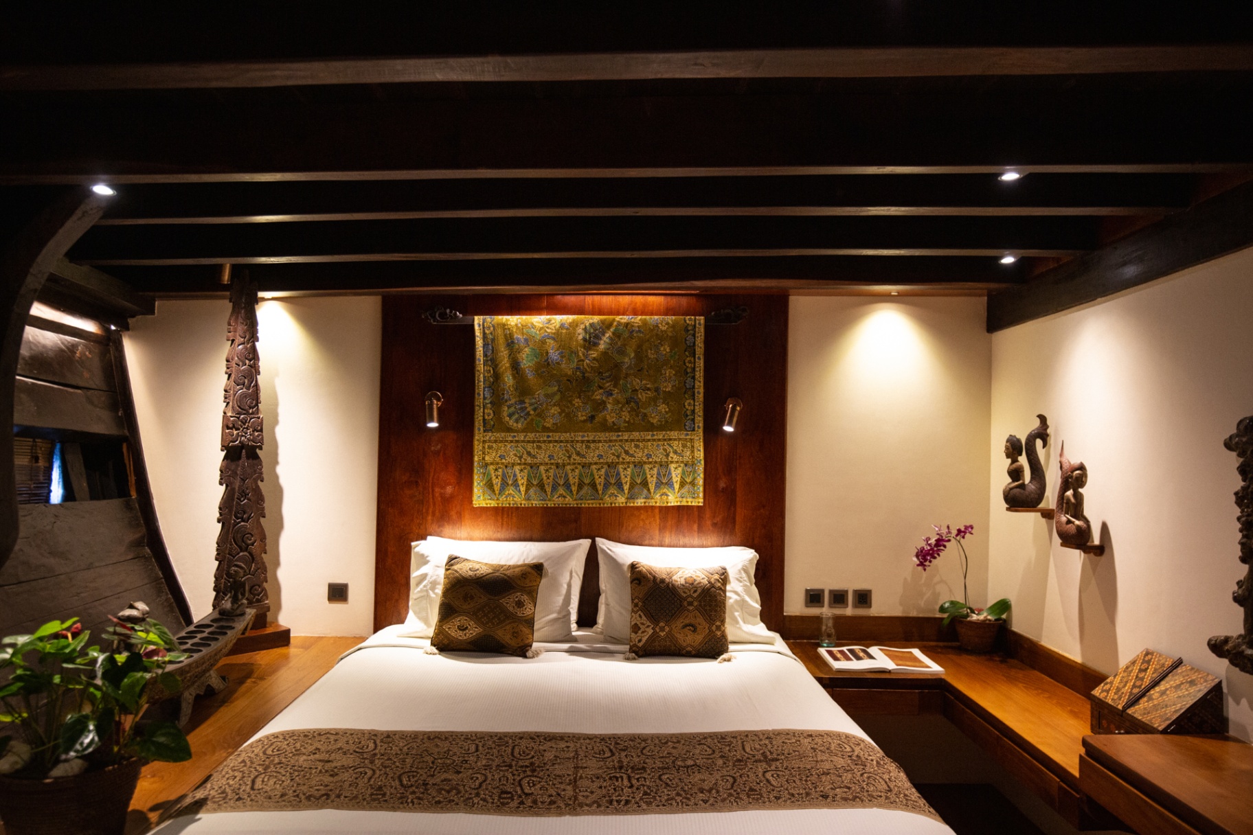 Master suite on Silolona with hand-painted Javanese batik hanging above the king bed