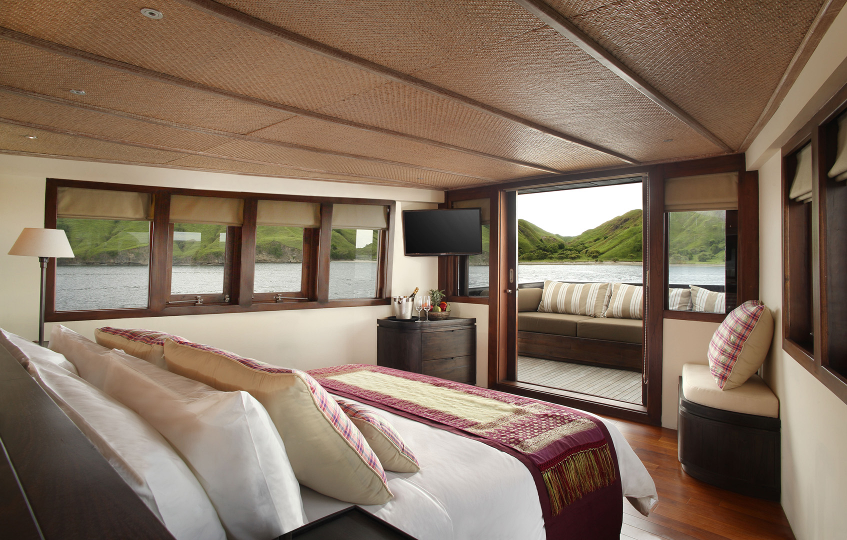 Sriwijaya Master Suite on Alila Purnama with king bed, wraparound windows and private balcony over Komodo