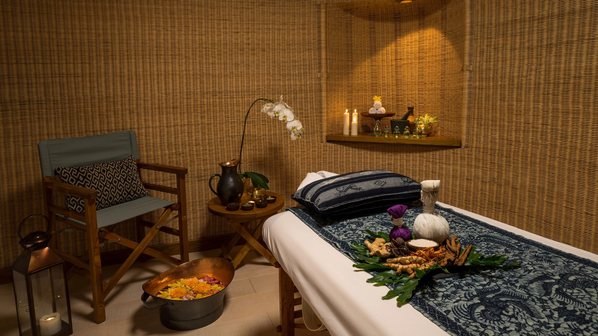 Java Spa treatment room on Kudanil Explorer with woven walls, candles and traditional herbs