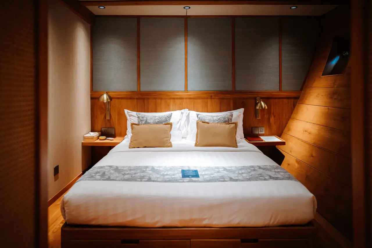 Celestia deluxe stateroom with queen bed and teak interior