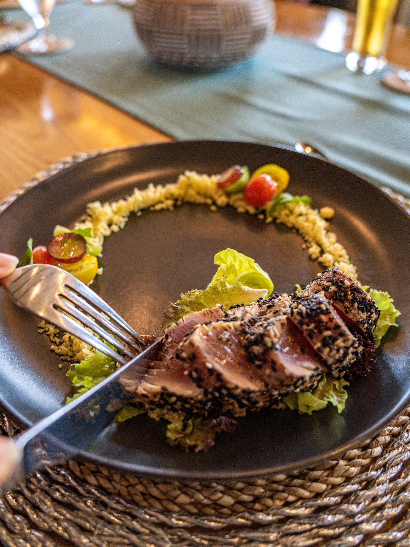 Sesame-crusted seared tuna tataki with couscous and heirloom tomato garnish plated at Lamima's table